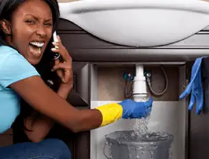 Emergency plumbing repair for a leaking sink drain under a bathroom vanity in Milwaukee, WI