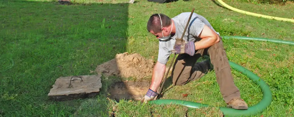 Septic pumping technician servicing a residential septic tank in Milwaukee, WI